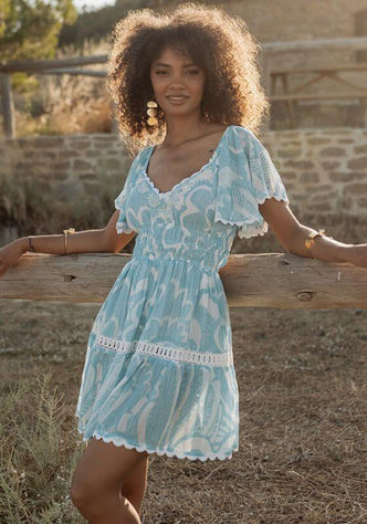 Shell Short Dress Blue by Piti Cuiti, featuring V neckline, embroidered details, and a tiered skirt.