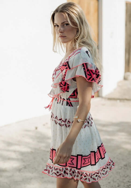 Sidi Kaouki Short Dress by Piti Cuiti, featuring vibrant neon pink embroidery and a flattering V-neckline.