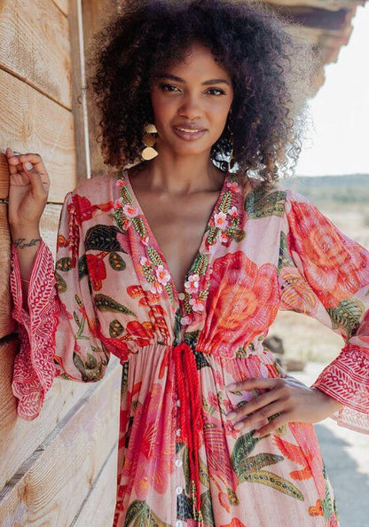 St Barths Beach Dress Orange by Piti Cuiti, vibrant dress with orange flowers and green leaves, showcasing tropical style.