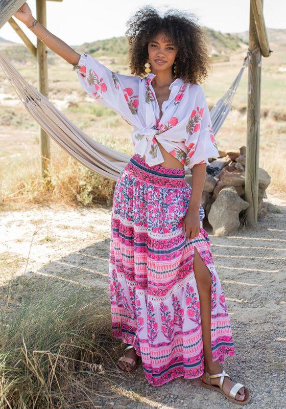 Zanzibar Long Skirt Pink Indigo by Piti Cuiti, showing a model in a relaxed flowy skirt with vibrant floral patterns.