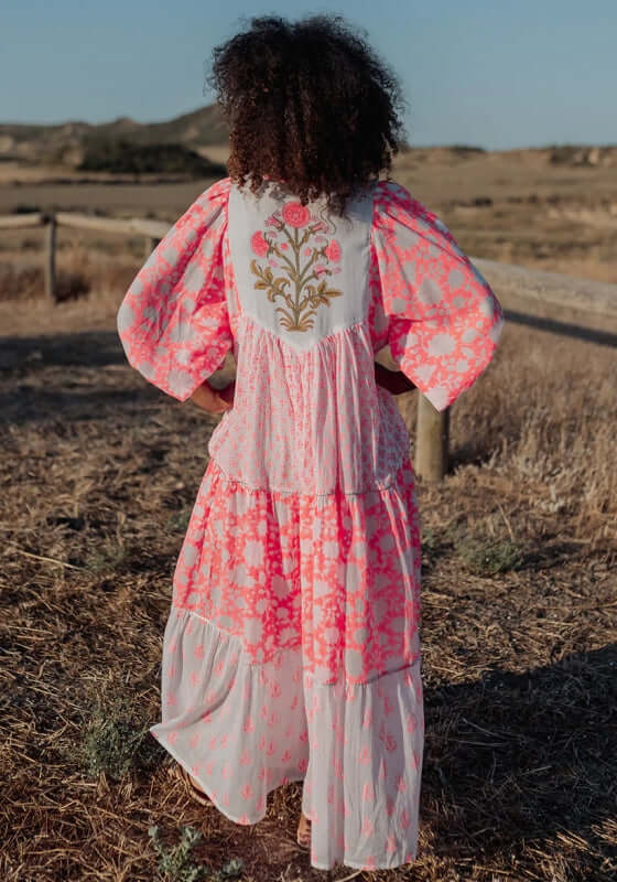 Ambar Long Beach Dress Orange Neon by Piti Cuiti featuring a vibrant floral print and voluminous balloon sleeves.