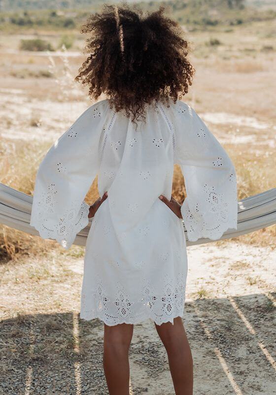 Santorini Dress White by Piti Cuiti, showing breezy embroidered anglaise fabric and flattering flare sleeves.