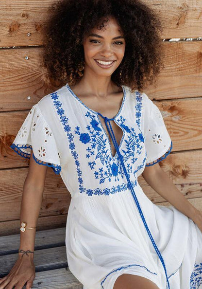 Tulum Long Dress Blue White by Piti Cuiti, featuring blue flower embroidery and scalloped hem in a relaxed setting.