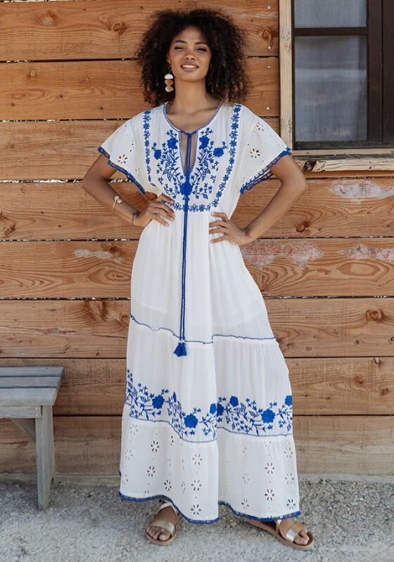 Tulum Long Dress Blue White by Piti Cuiti, featuring embroidered blue flowers and a flowing scalloped hem.