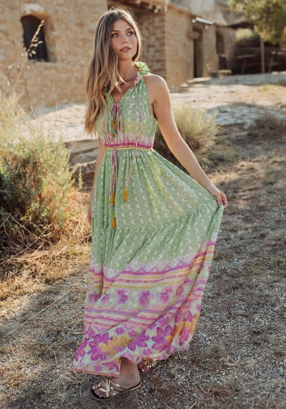 Curacao Dress Green by Piti Cuiti featuring a ruffled collar and a tiered skirt with pink and green patterns.