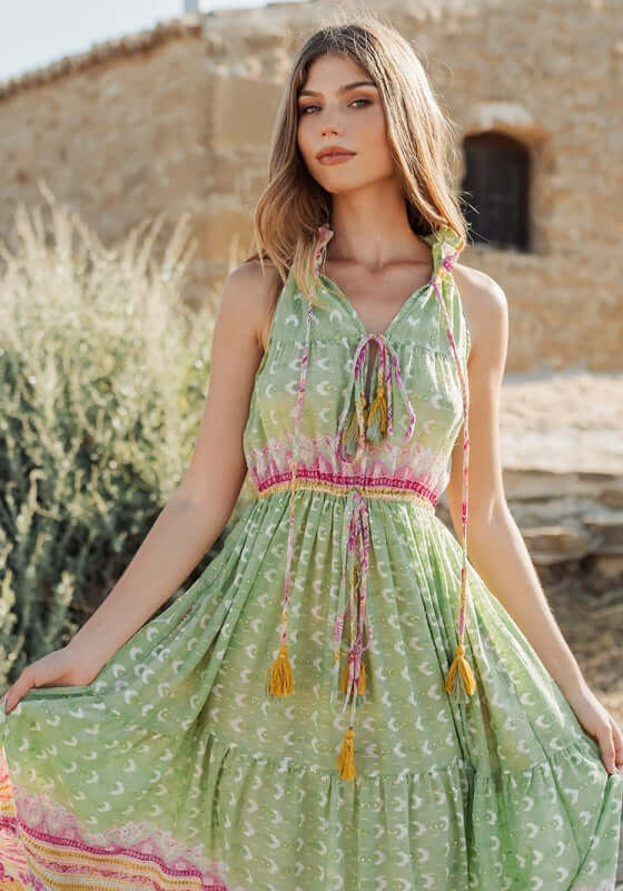 Curacao Dress Green by Piti Cuiti, showcasing a green maxi dress with ruffled collar, tiered skirt, and tassels.