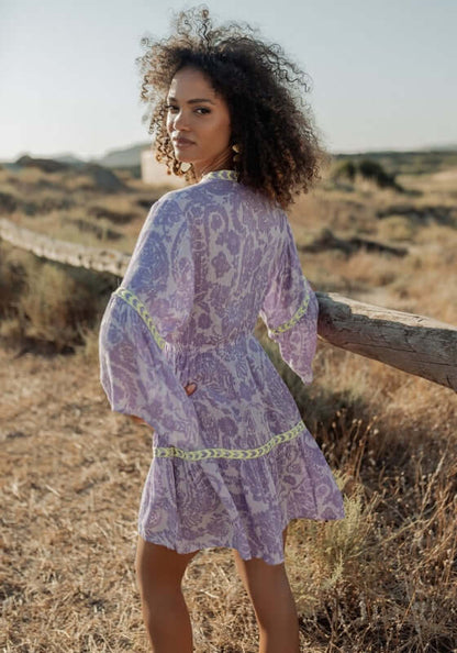 Sahara Purple Dress by Piti Cuiti, featuring a rich purple design with lime green details and balloon sleeves.