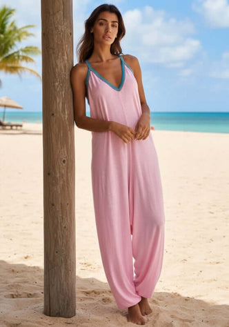 Pima Jumpsuit Light Pink by Pitusa on a beach, showcasing relaxed style and soft pima cotton in an elegant look.