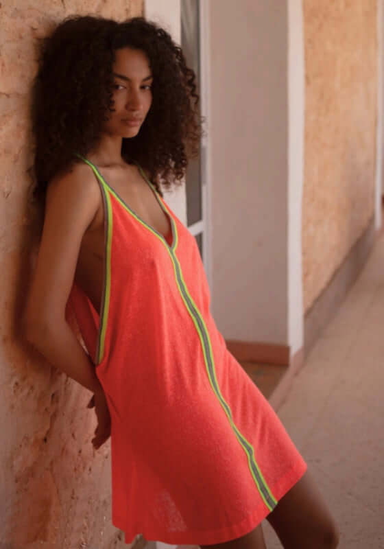 Inca Mini Dress Watermelon by Pitusa, featuring a model in a soft semi-sheer jersey dress with vibrant embroidered details.