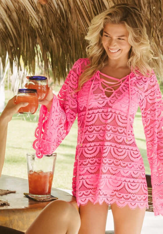 Tulip Noah Tunic by PQ Swim worn by a smiling woman in neon pink lace, perfect for beach outings.