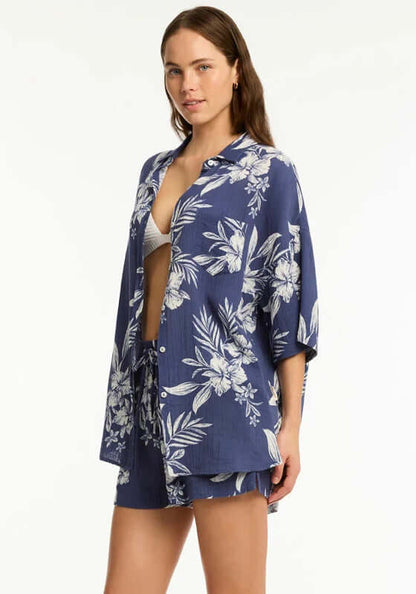 Aloha Beach Shirt French Navy by Sea Level, a woman in a floral navy shirt and shorts, perfect for beach days.