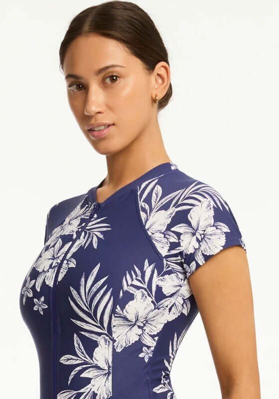 Aloha Short Sleeved Zip Front Swimsuit by Sea Level, featuring a floral design and short sleeves for summer style.