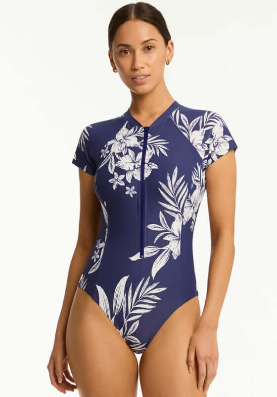 Aloha Short Sleeved Zip Front Swimsuit by Sea Level featuring a floral navy design and short sleeves, perfect for summer.