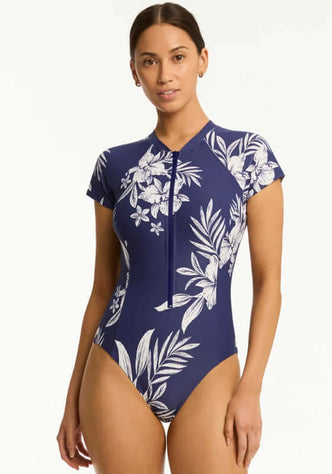 Aloha Short Sleeved Zip Front Swimsuit by Sea Level featuring a floral navy design and short sleeves, perfect for summer.
