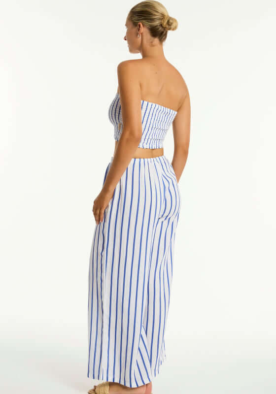 Amalfi Beach Trousers Blue by Sea Level, model wearing blue and white striped trousers from the back.