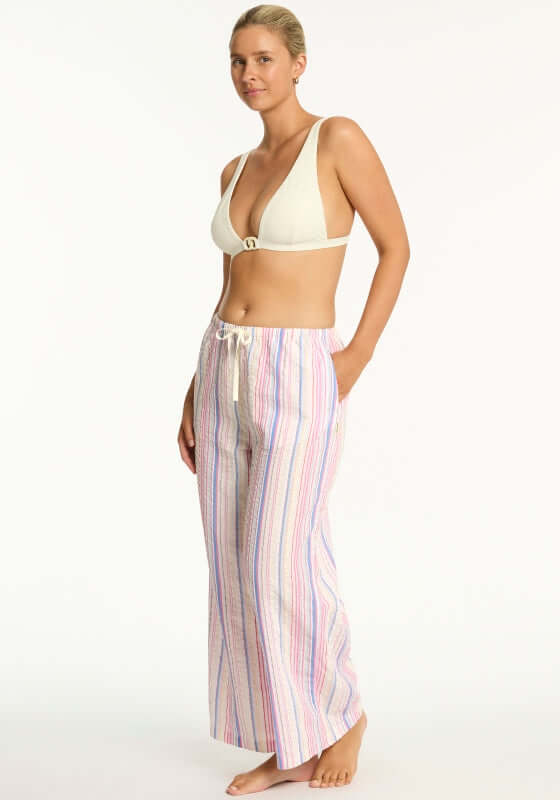 Boho Stripe Beach Trousers Blue by Sea Level, featuring a model wearing wide leg trousers with a drawstring waist and side pockets.
