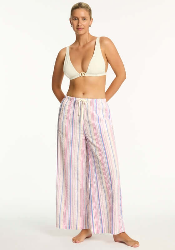 Boho Stripe Beach Trousers Blue by Sea Level, featuring a model wearing wide-leg trousers with a drawstring waist.