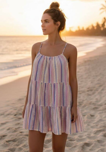 Boho Stripe Beach Dress Blue by Sea Level, model wearing a striped dress on the beach at sunset.