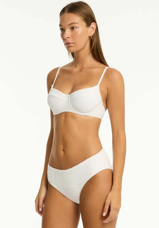 De Soleil Balconette Bikini White by Sea Level modeled on a woman, showcasing adjustable straps and eco-friendly design.