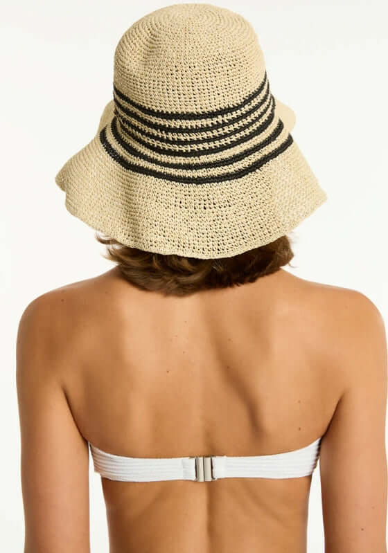 Back view of a woman wearing a Gili Beach Hat, showcasing its stylish foldable design and adjustable size feature.