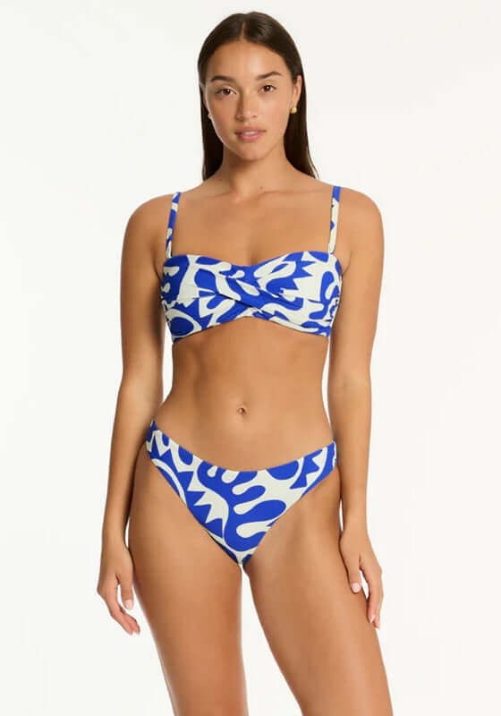 Seascape Twist Bandeau Bikini by Sea Level model wearing stylish blue and white textured fabric swimwear.