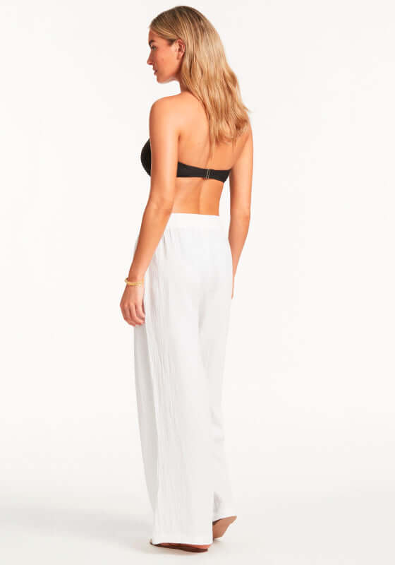 Sunset Beach Trousers White by Sea Level worn by model, showcasing breathable cotton with wide-leg design and drawstring waist.