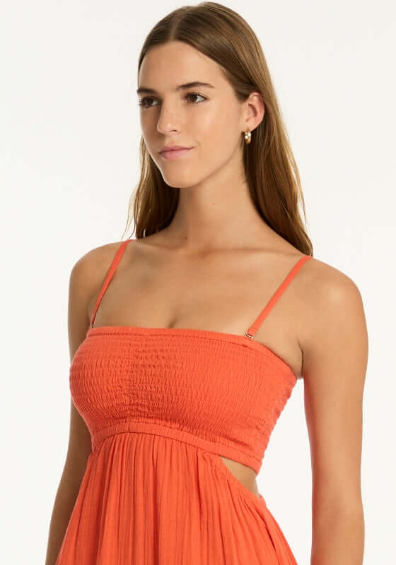 Sunset Bandeau Dress Flame by Sea Level, model wearing a vibrant red flame bandeau dress with a shirred bust.