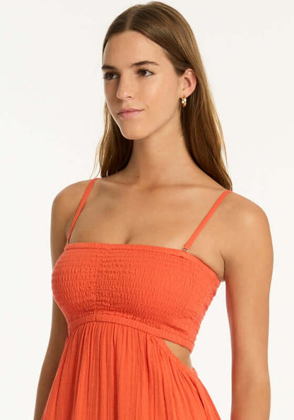 Sunset Bandeau Dress Flame by Sea Level, model wearing a vibrant red flame bandeau dress with a shirred bust.