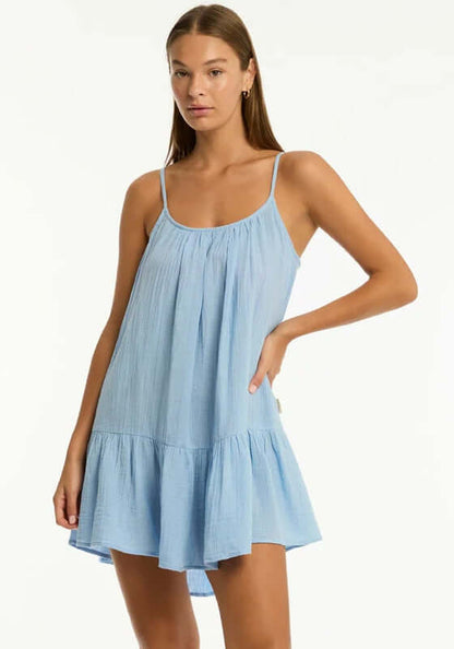 Sunset Short Sundress Cornflower Blue by Sea Level, a model wearing a light blue tiered sundress made from breathable cotton.