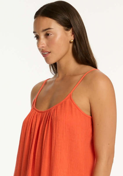 Sunset Short Beach Dress Flame by Sea Level, model wearing a flowy orange dress with spaghetti straps, hair down.
