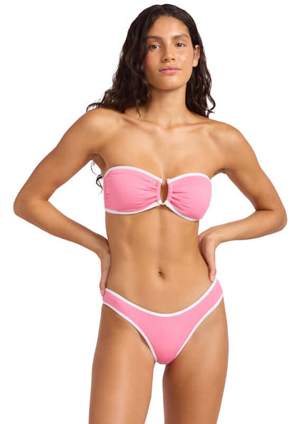 Beach Bound Bandeau Bikini Begonia Pink by Farm Rio. Model wears pink bandeau bikini with ring detail and ecru piping.