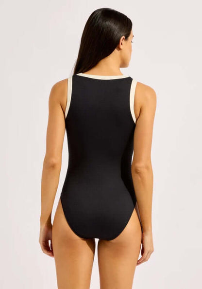 Bandwave Zip Front Swimsuit by Seafolly, showcasing the back view of a sleek black one-piece with white band piping.
