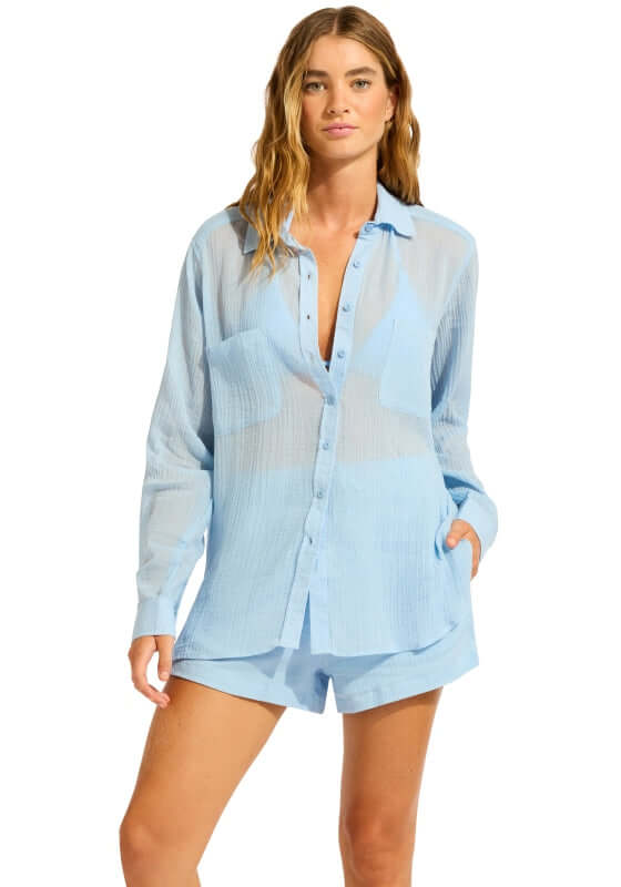 Breeze Beach Shirt Cornflower by Seafolly, featuring a light blue button-up shirt with roll-up sleeves.