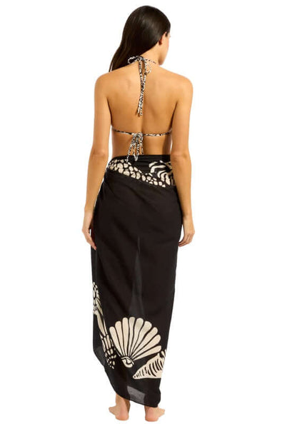 C Shells Sarong by Seafolly, showcasing a woman wearing the lightweight sarong with a shell print design.