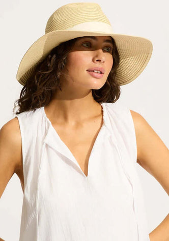 Collapsible Fedora by Seafolly, a natural packable beach hat worn by a model, perfect for holiday travel.