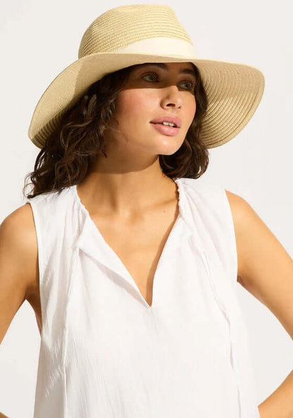 Collapsible Fedora by Seafolly, a natural packable beach hat worn by a model, perfect for holiday travel.