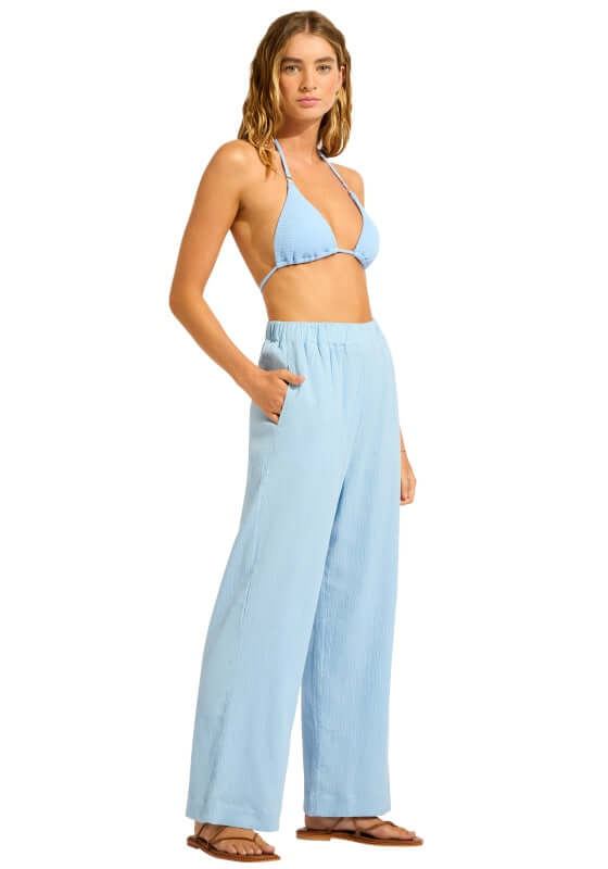Crinkle Beach Trousers Cornflower Blue by Seafolly model wearing loose trousers with side pockets and drawstring waist.