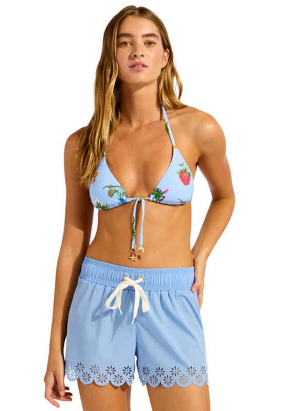 Boardshort Powder Blue by Seafolly, model wearing Powder Blue boardshorts with daisy embroidery, perfect for beachwear.