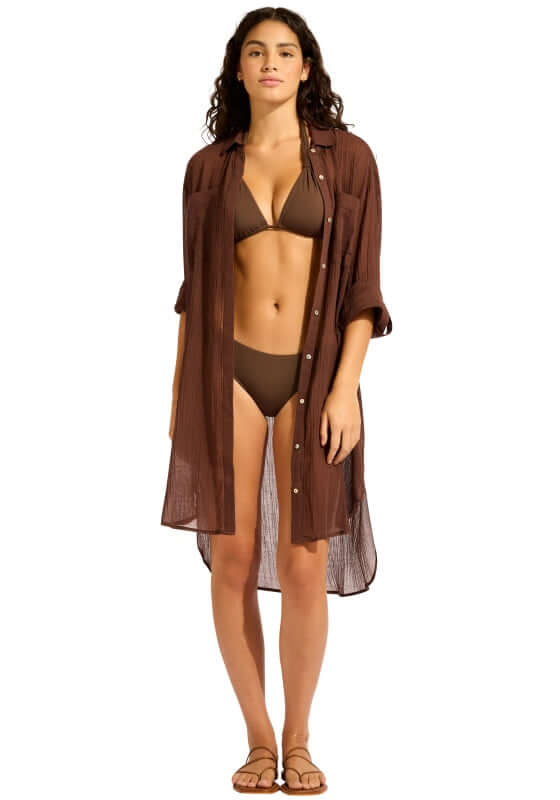 Crinkle Twill Beach Shirt Dark Chocolate by Seafolly, model wearing the shirt over a bikini at the beach.
