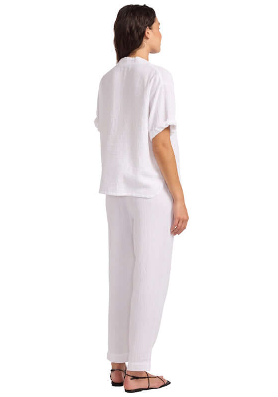 Double Gauze Tapered Beach Trouser by Seafolly, featuring a woman wearing white beach trousers from the back.