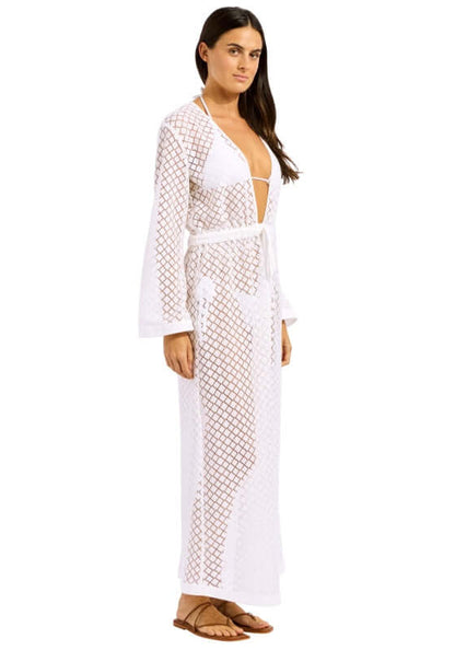 Gathered Lace Cover Up by Seafolly, showcasing a model in a white lace cover up with a deep V neckline and flowing sleeves.