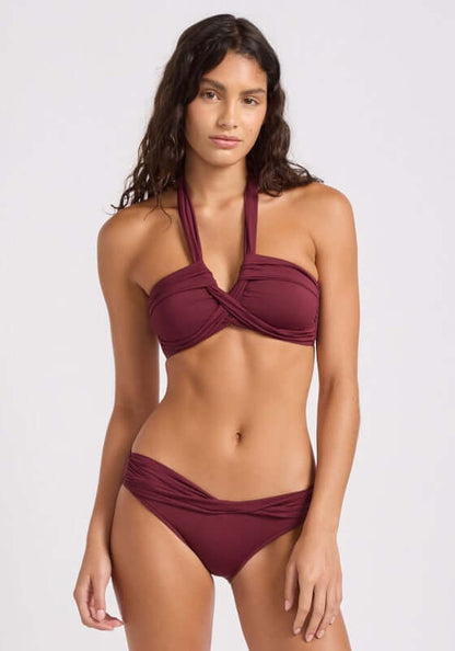 Goddess Bandeau Bikini Burgundy by Seafolly model wearing a dark burgundy bandeau bikini with halterneck top and medium coverage bottoms.