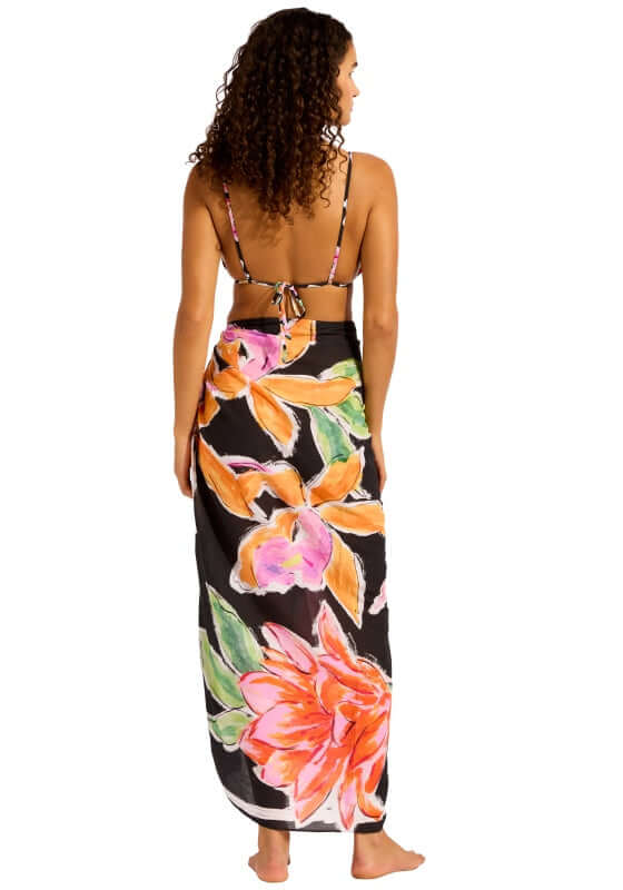 Black House of Flowers Sarong by Seafolly, showcasing vibrant floral print on a black background, worn as a beach cover-up.