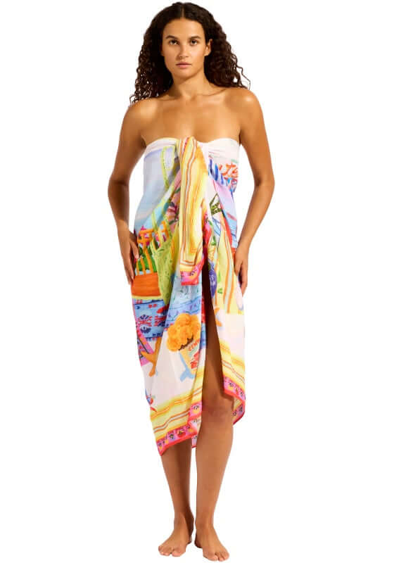 La Boca Sarong by Seafolly, a model showcasing vibrant beachwear tied as a dress, perfect for stylish beach days.