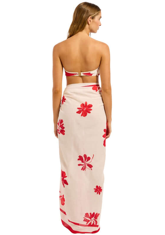 Mayflower Sarong Cosmo Red by Seafolly, showing a model in a vibrant red floral print sarong on an ecru background.