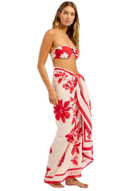 Mayflower Sarong Cosmo Red by Seafolly, featuring a model wearing a vibrant red floral wrap against an ecru background.