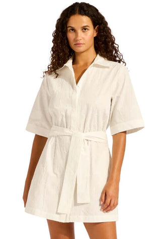 Mini Shirt Dress White by Seafolly model wearing a short-sleeve white dress with a tie waist and button-through design.