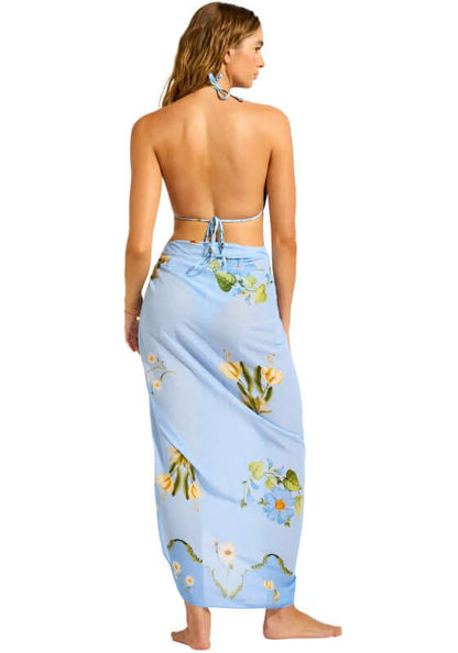Modern Romance Sarong Powder Blue by Seafolly model wearing a floral print sarong with a back view at the beach.