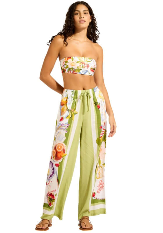 Riviera Coast Beach Trousers by Seafolly, featuring a model wearing lightweight floral print trousers with side pockets.