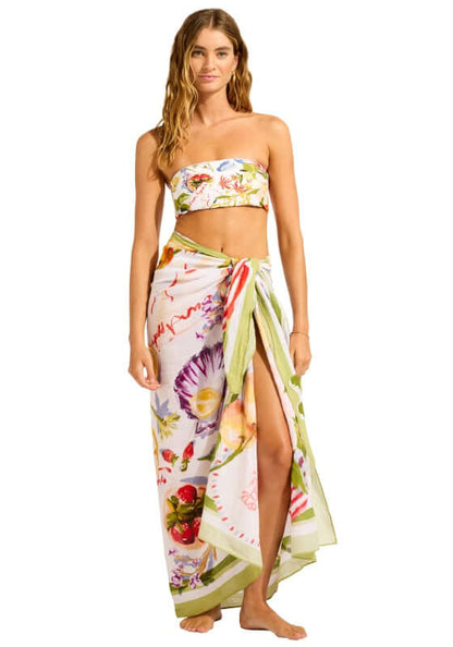 Riviera Coast Sarong by Seafolly, featuring a model wearing a vibrant floral sarong styled by the beach.